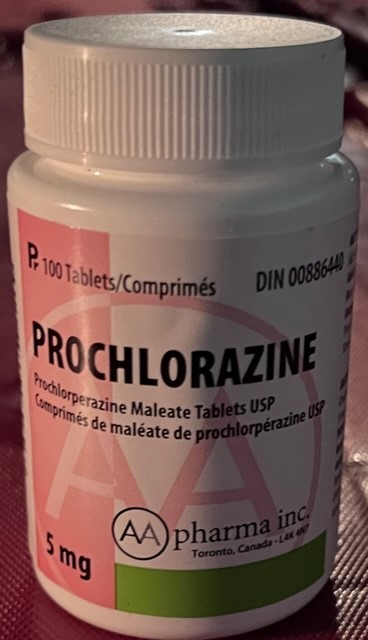 A large white tablet bottle. The label says Prochlorperazine in bold lettering. There's a big pink block of colour and a large pink logo with the letters A A sits behind the text. . 