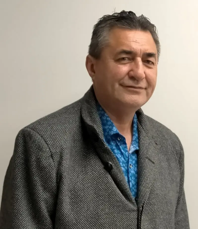 Trevor is a Māori man of more senior years. He looks at the camera warmly..