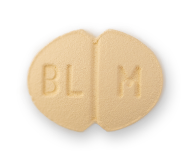 An oval tan pill with indents on the long side. THere's a centre score and the letters BL M etched on it