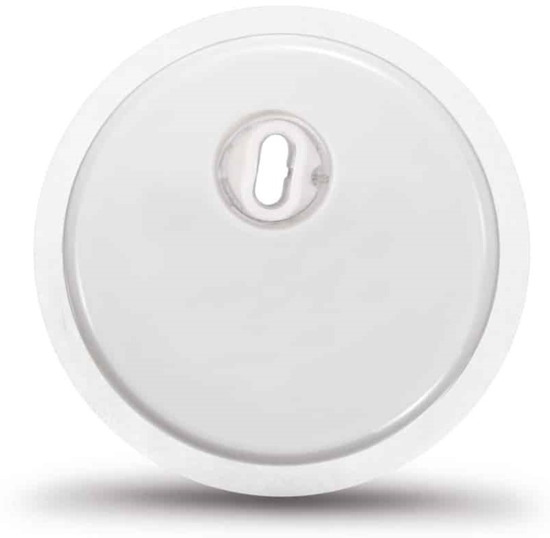 A round white device, it has a small hole at the top